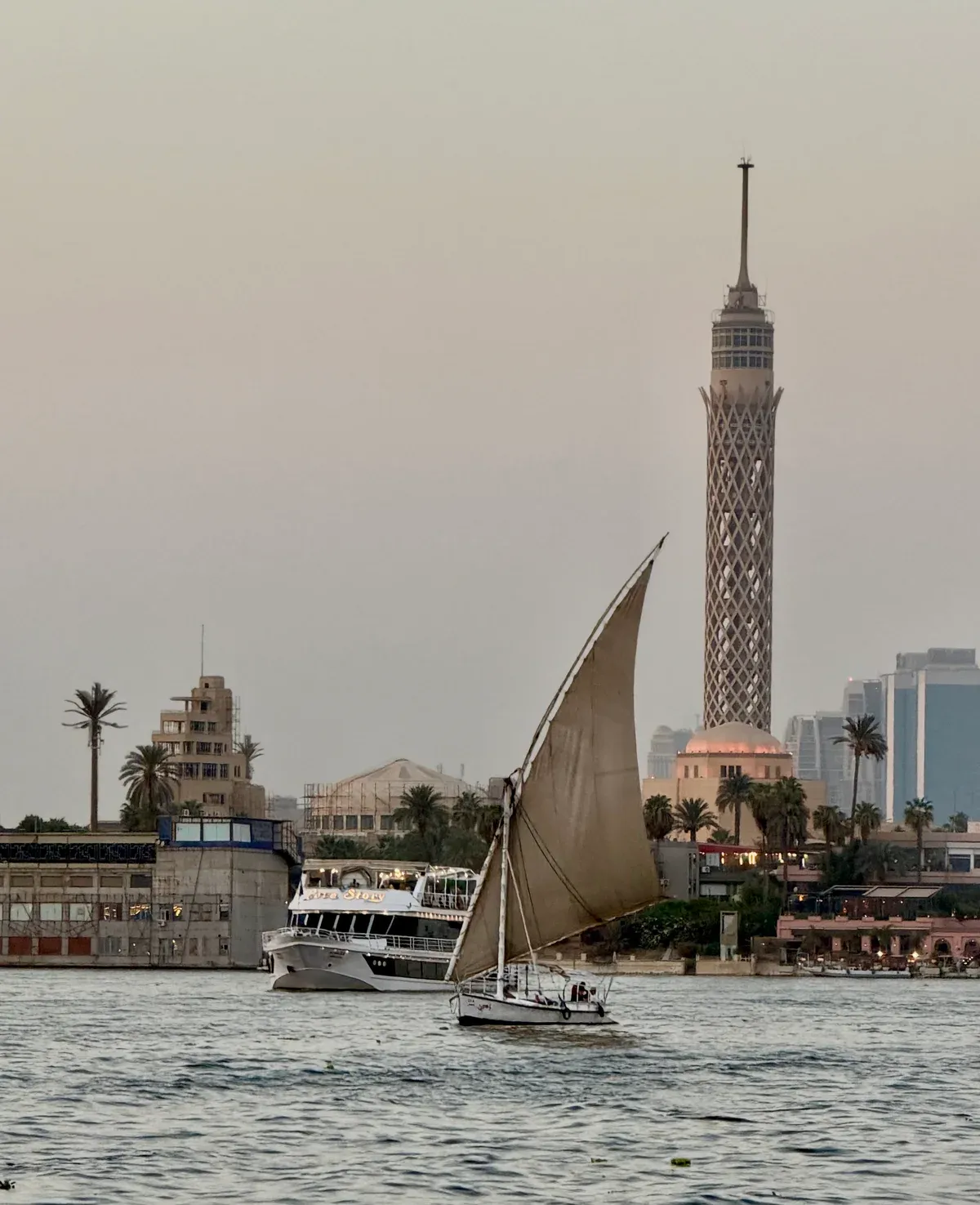 A felucca sailing past the Cairo Tower on the Nile in Cairo, as on a Nile felucca ride