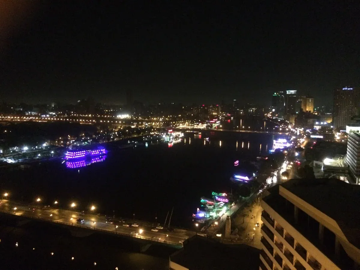 A lit boat on the Nile in Cairo at night, as seen on a Nile dinner cruise