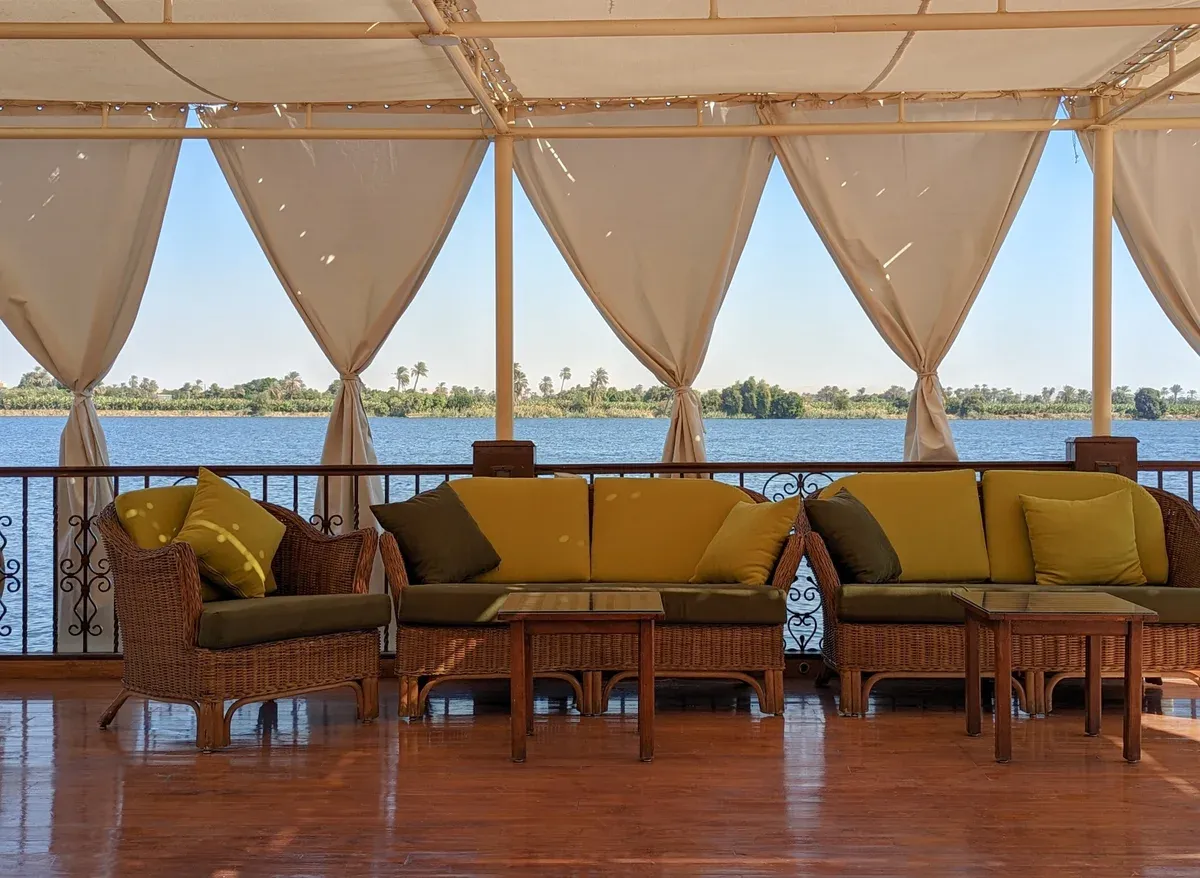 The shaded lounge deck of a dahabiya on a Nile river cruise