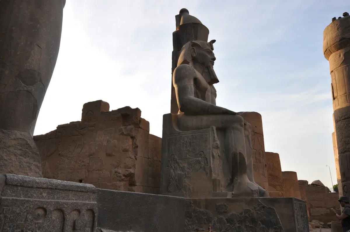 A seated statue of Ramesses II in Luxor Temple, visited on a Nile cruise stopping in Luxor